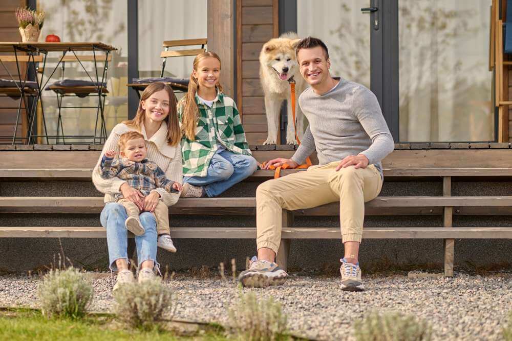 Smiling family outside their house in Bentonville & Centerton homes