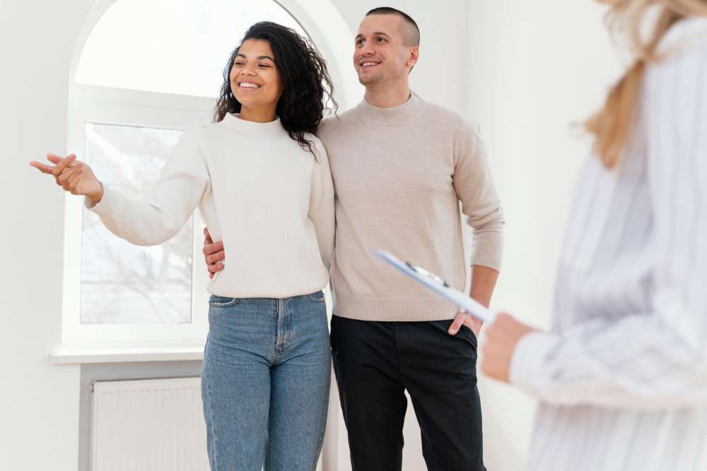 Happy homebuyer couple exploring Bentonville & Centerton homes
