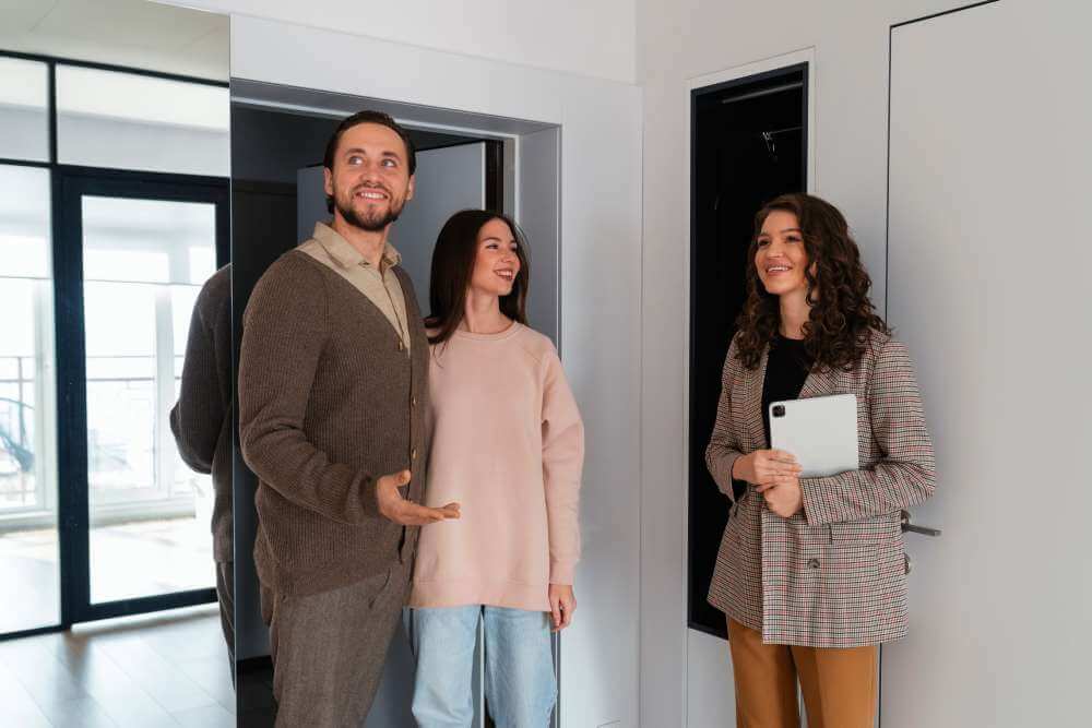 Real Estate Agent showing home to young couple