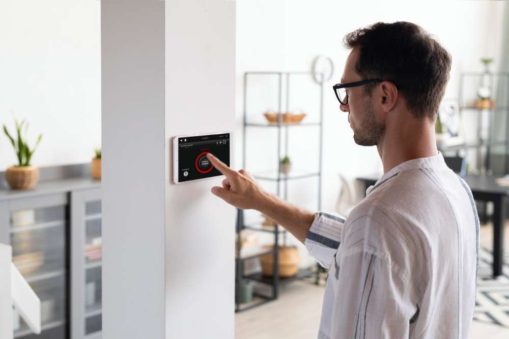 Man using smart security system in real estate Centerton AR home