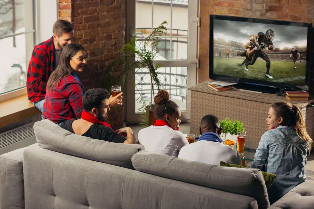 Group of friends enjoying watching football game