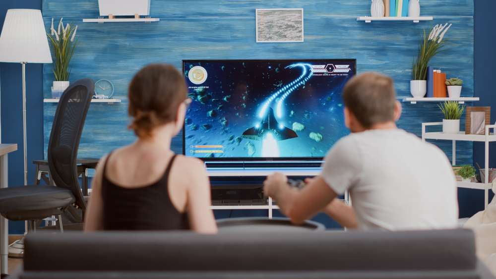 Young Couple playing console gaming over internet